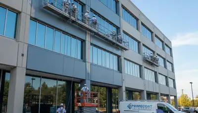 Professional commercial building painters in Fresno CA applying durable exterior paint finishes