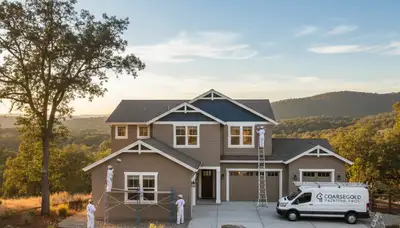 Professional house painters working on exterior home repaint in Fresno, CA