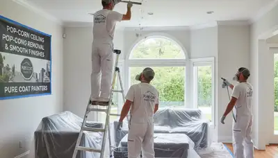 Painter removing popcorn ceiling in Fresno, CA home for smooth modern finish by local painting experts